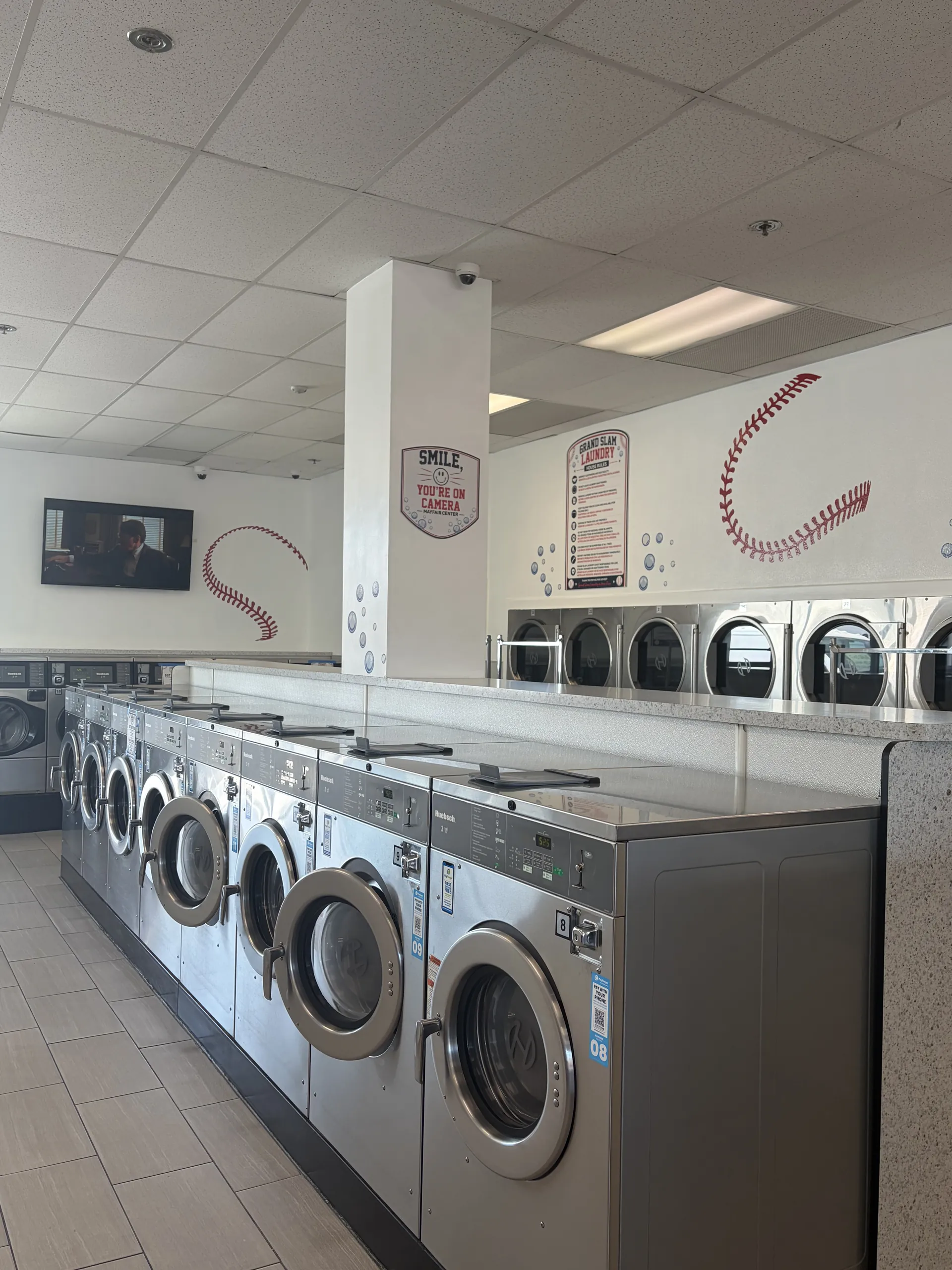 Row of coin-op washers with baseball stitching wall decal
